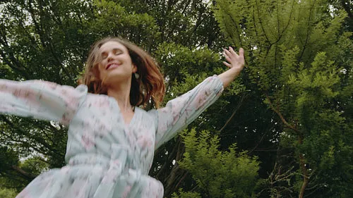 Cheerful woman dancing with joy